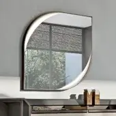 Elegant Turri Vine Teardrop mirror with brushed gold metal frame and soft leather applications illuminated by hidden internal lighting