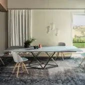 Elegant Bontempi Delta table with a light gray tabletop and dark matte metal geometric base crafted in Italy