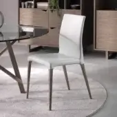 Distinguished Pacini & Cappellini Eva chair with solid ash wood structure and smooth white upholstery exhibiting a matte finish