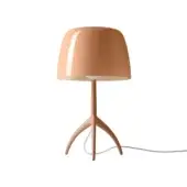 Foscarini Lumiere Nuances table lamp, pink, large rounded shade with vertical slit, curved three-leg base, glossy finish.