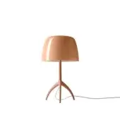 Foscarini Lumiere Nuances table lamp in pink, rounded mushroom shade, slender three-leg stem, glossy finish, minimalist sculptural form.