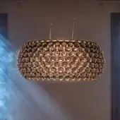 Exceptional Foscarini Caboche Plus suspension lamp crafted with transparent arches and PMMA spheres in a golden honeycomb structure with aluminum base and powder coating
