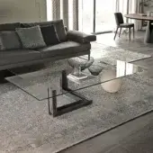 Superior Cattelan Italia Levante coffee table with a transparent glass top and rough steel beam built with natural travertine