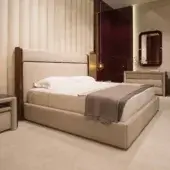 Distinguished Turri Madison bed with glossy dark-lacquered wood and light beige leather detailing showcasing gold metal accents