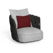 Armchair, light gray fabric upholstery, rounded shape with dark gray cord armrests and burgundy pillow accent.