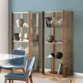 Elegant Pacini & Cappellini Bay showcase with Canaletto walnut frame and clear glass panels embodying a contemporary style