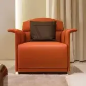 Elegant Turri Madison lounge chair with bright orange upholstery and dark brown wooden base exhibiting vertical line embroidery