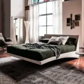 Superior Cattelan Italia Dylan bed with curved headboard upholstered in dark green synthetic material and chromed steel feet