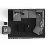 Gray modular sectional sofa with chaise, striped pillows on dark gray fringed rug, with black cube and textured panels.