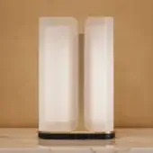 Exceptional Turri Madison table lamp with opaque white glass sections and satin metal structure built with a black and gold base
