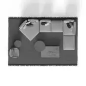 Living room arrangement, gray modular sofa, textured area rug with fringe, round accent tables—one gray, one wood—and rectangular ottoman.