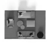 Living room arrangement with gray sectional sofa, walnut tables, light gray ottoman, and dark gray circular rug on a white backdrop.