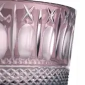 Crystal glass, aubergine, faceted design with textured base and vertical ridges featuring starburst cutouts, iridescent sheen.