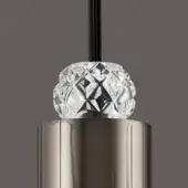 Cylindrical metal lighting component with vertical grooves, topped with a diamond-cut glass sphere and black cord, on a gray background.