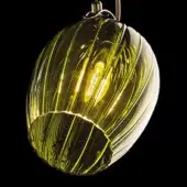 Olive green glass pendant light, spherical shape, striated texture, warm glow, brushed metal fitting, silver cable suspension.