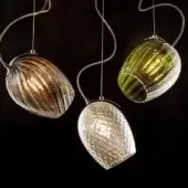 Pendant lights, glass and metal, feature ridged gold, ribbed olive green, and textured transparent shades suspended from spiraling silver cables.