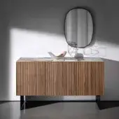 Distinguished Sovet Italia Kala sideboard with vertically ribbed wood body, stone top, brass profile and dark metal base in a matte finish
