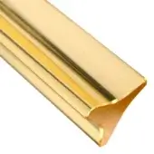 Decorative molding, amber resin, triangular corner profile with polished metallic finish and bright highlights against a white backdrop.