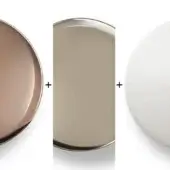 Gold, nickel, and white circular elements arranged vertically with plus signs, showcasing metallic and matte finishes on a white background.
