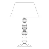 Table lamp black and white line drawing, trapezoidal shade, tiered ornate base with fluted details and stepped foot, classic geometric design.