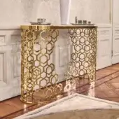 Elegant Longhi Manfred console with laser-cut metal base in a glossy golden finish and light-colored solid surface top