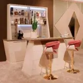 Exclusive Vismara Hemingway Bar counter crafted in matt lacquered glass with gold-toned metal pedestal bases and darker brown shelving