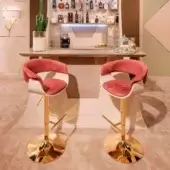 Lavish Vismara Joyce stool with gently curved silhouette upholstered in dusty rose Velvet and gold-plated steel base