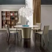 Distinguished 4 Mariani Papier table with grey veined marble tabletop and supple saddle leather curved base exhibiting a polished finish