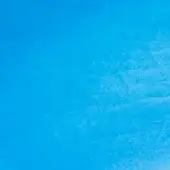 Bright blue textured surface with mottled pattern, uneven granular appearance, and diffused lighting creating tonal variations in the solid material.