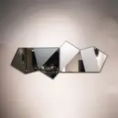Origami mirror by Sovet Italia, mirrored panels, dark gray frame, angular shape, reflecting modern interior with sofa and cabinet.