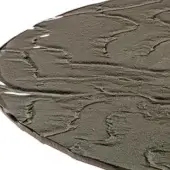 Smoked cast glass tabletop, circular shape, topographical texture with raised ridges and valleys, uneven chipped edges, studio lighting.