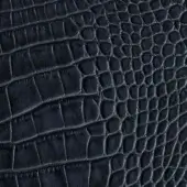 Dark grey alligator-embossed leather texture with repeating rectangular scales, matte finish, and visible “pinetti” brand label.