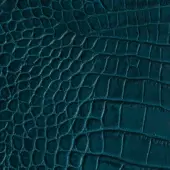 Blue alligator-embossed leather texture with repeating rounded nodules and linear channels, exhibiting a matte finish and natural grain.