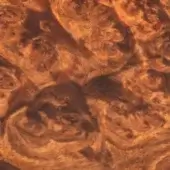 Radica wood texture displaying swirling brown and tan grain patterns, with polished surface and contrasting dark areas, showcasing dense organic forms.