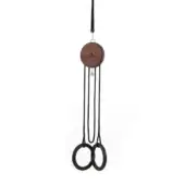 Wind chime with walnut wood top and two matte black infinity rings suspended by black cords against a white backdrop.