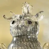 Glass owl sculpture with smoky base, gold flecks, rounded eyes, curved ears, and layered crest in Murano style.