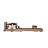 Vintage rowing machine, wood frame, brown finish, rectangular base, clear water tank, cushioned dark brown seat, yellow warning labels.