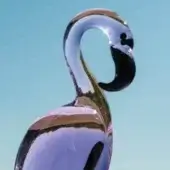 Flamingo sculpture, purple and silver gradient, curved neck and streamlined body, glossy finish, black beak and legs, light blue sky background.