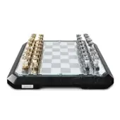Chess set, black marble and acrylic, mirrored board with teal trim and gold metal pieces, Teckell branding, white background.