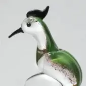 Glass woodpecker sculpture, translucent green with white & black accents, detailed profile view, hand-blown texture, red & brown flecks.