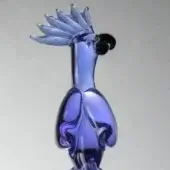 Glass parrot sculpture, alexandrite purple, with elongated crest and translucent swirls, displayed on a gray gradient backdrop.
