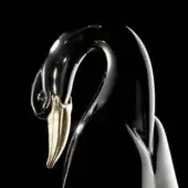 Duck sculpture, black resin, elongated form with gold beak and white neck, reflective surface, pearl detail on head, against black background.
