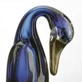Glass duck sculpture, deep blue with gold flecks, curved neck and amber-to-clear beak, glossy finish, studio shot on white background.