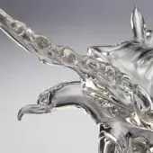 Transparent sculpture of eagle wings, clear material with internal bubbles, fluid organic shape, upward curving form, gradient gray background.