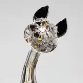 Glass cat sculpture, clear with multicolored inclusions, featuring black ears and a curved neck with yellow-brown striations.