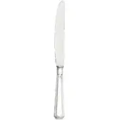 Stainless steel table knife with a curved blade and ribbed, fluted handle, studio shot on a white background with a circular mark.