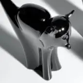 Black cat sculpture, polished resin, crouching pose with elongated limbs and stylized features, white background, dramatic lighting.
