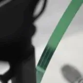 Bicycle fork with green glass disc brake rotor, labeled “ciclotte”, features a minimalist design against a light gray studio backdrop.