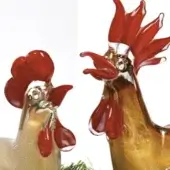 Glass hen and rooster sculptures, white/gold and amber/gold, with rounded and elongated forms, red glass combs, glossy finish.