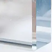 Glass structure with beveled edges, clear transparency, and vertical “intervallo” text, reflecting white and reddish-brown tones.